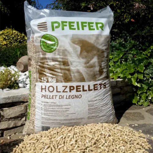 Large 15 kg bag of Pfeifer Holzpellets with loose wood pellets spilled in front, outdoors in a garden.